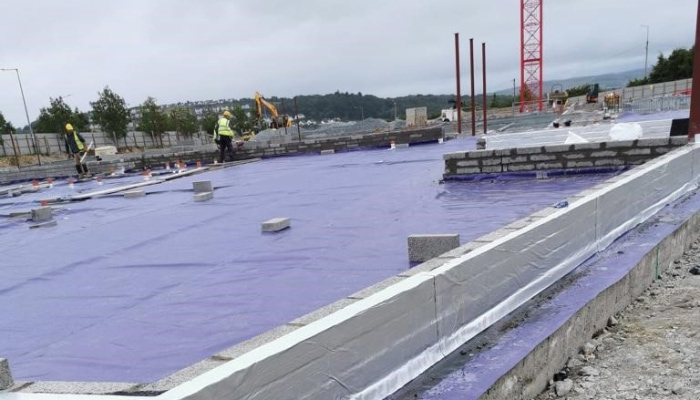 industrial construction site with radon barrier being installed